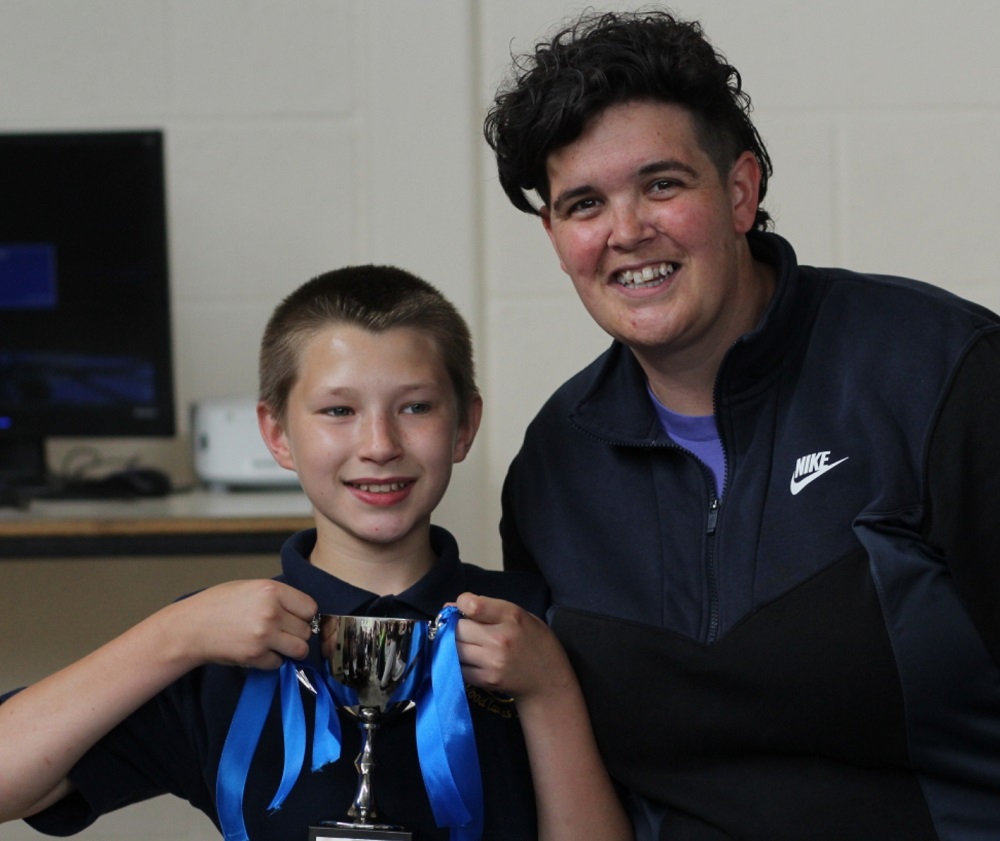 Pupil with Headteacher holding up the Sports Day 2023 Trophy