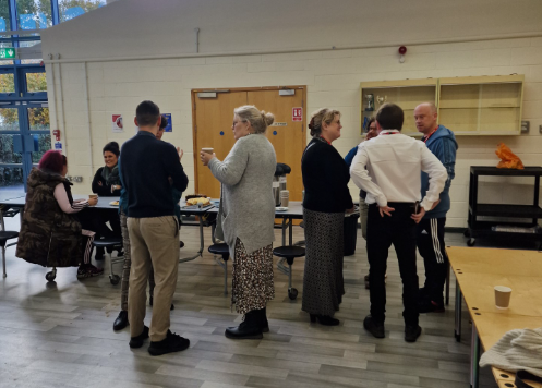 Parent and staff chat over coffee